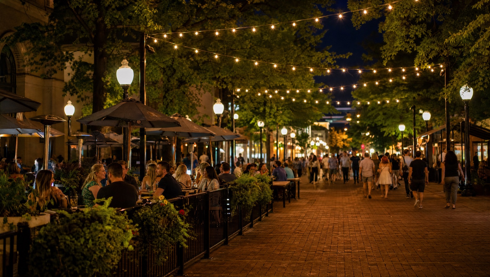 The Downtown Mall at night with string lights and full restaurant patios